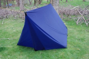 Blue tent on green grass